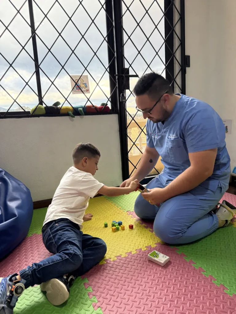David Iñiguez estimulando procesos cognitivos con un niño mediante juego con cubos