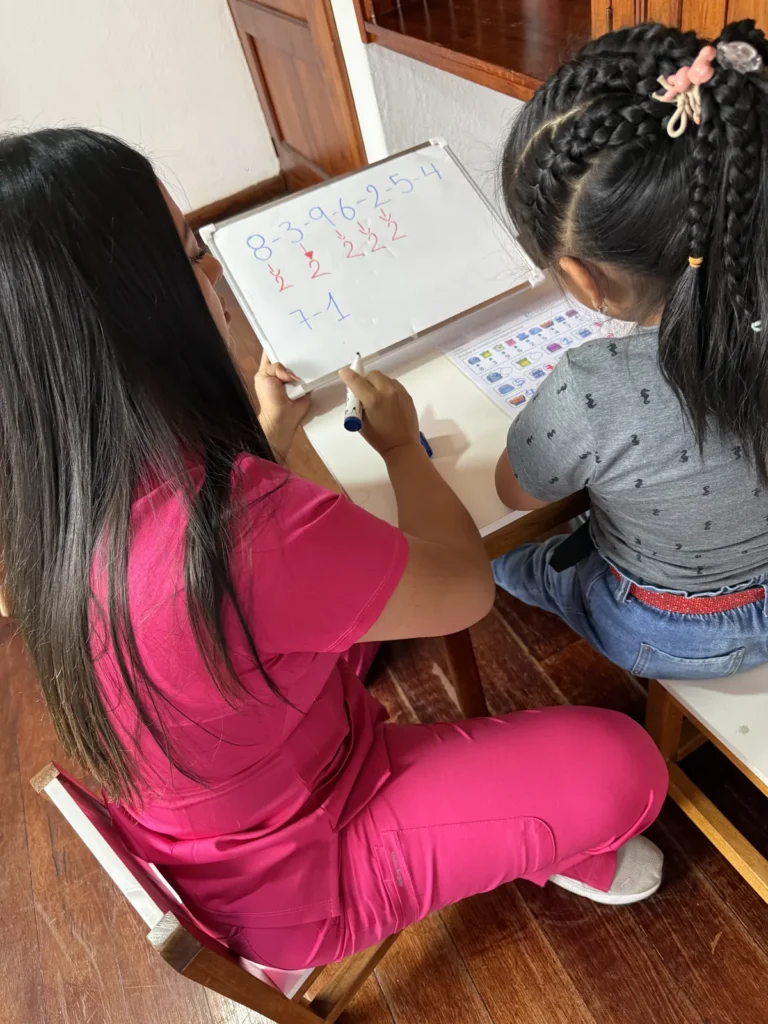 Especialista de CALMA orientando el proceso de aprendizaje de una niña